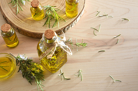 Containers with rosemary essential oil on a wooden table, a Health & Medical Photo by Davizro's Market