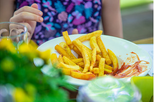 A child eats French fries. Selective, a Food & Drink Photo by yanadjana