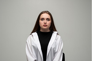 Young woman posing in a studio for a, a Person Photo by volodymyrshtun13795
