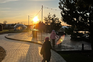 Family walking along a park trail at sunset in a peaceful environment, a Photo by AS photostudio