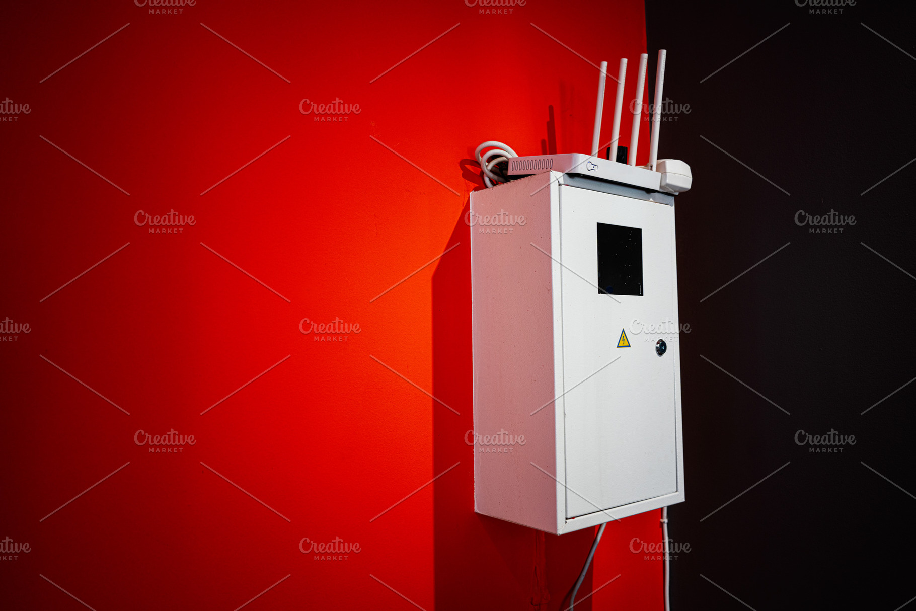 White equipment cabinet against a red and black wall in a modern setting, a Photo by AS photostudio