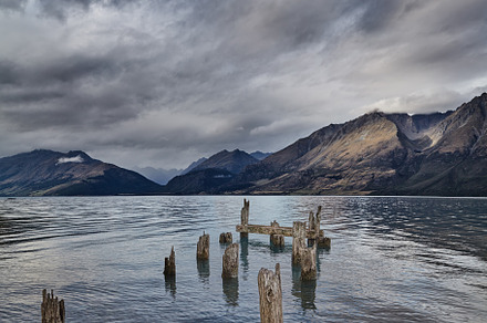 Mountain lake with old ruined pier