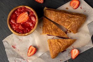 puff pastry with strawberries, a puff pastry bun with strawberry and cherry fla, a Photo by rsoollAI