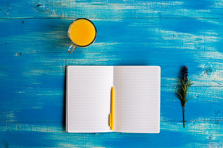 Notebook, healthy food, orange juice