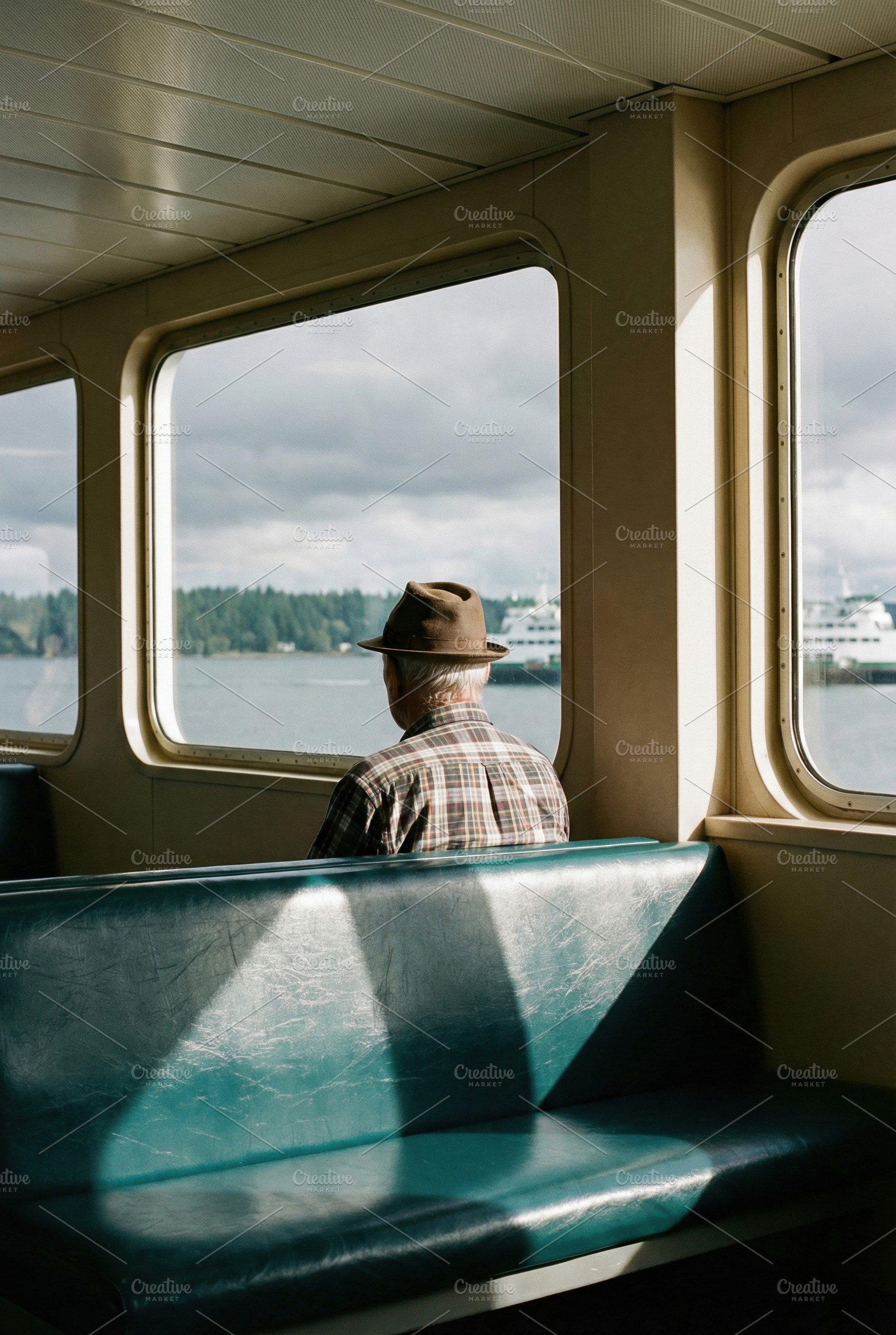 Elderly Man Looking Out Ferry Window, a Person Photo by Virgo Studio
