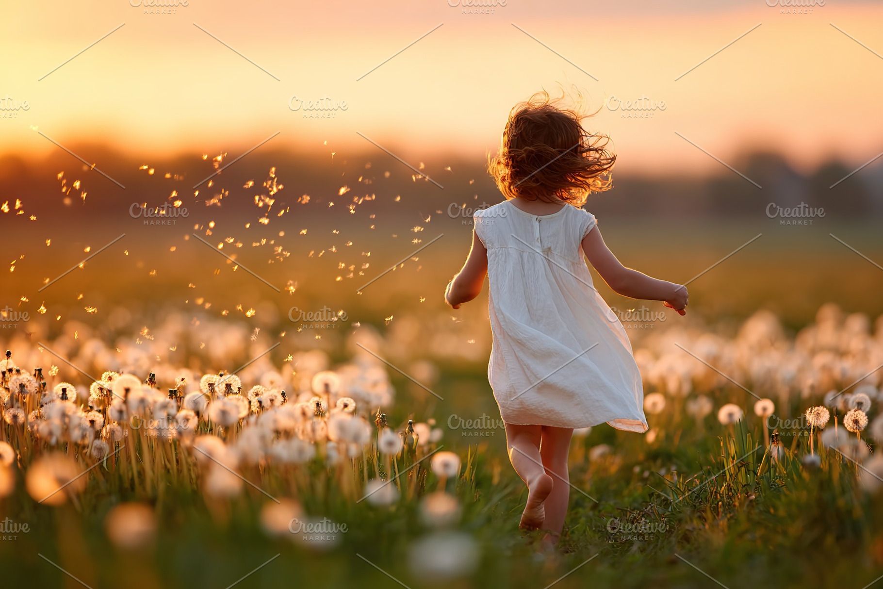 Child runs through dandelion field at sunset enjoying a carefree moment in natu, a Photo by AlyaAnd
