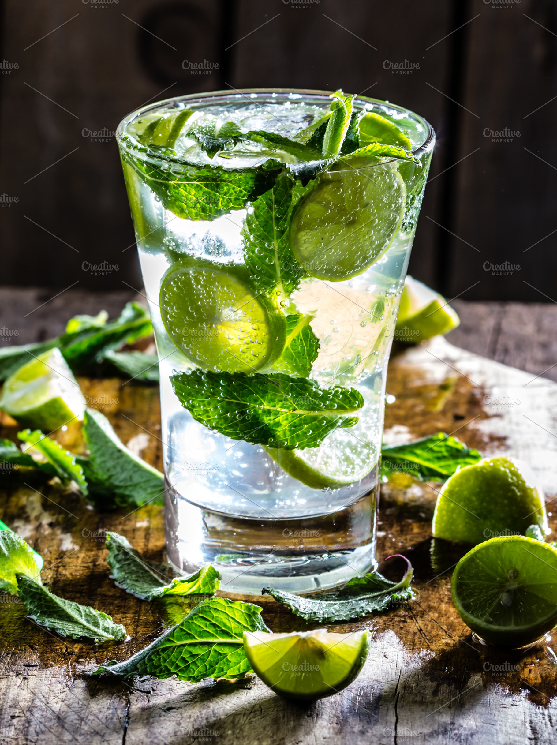 Mojito cocktail with lime and mint on wooden rustic background stock photo, a Food & Drink Photo by LARISA BLINOVA