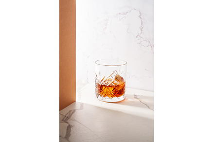 Whiskey with ice cube in the glass