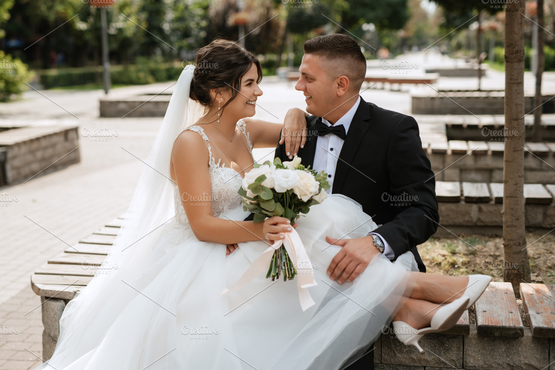 the groom in a brown suit and the bride in a white dress, a Person Photo by Weddings, People, Travel