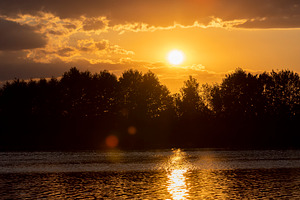 the lake with orange water in the summer at sunset, a Photo by rsoollAI