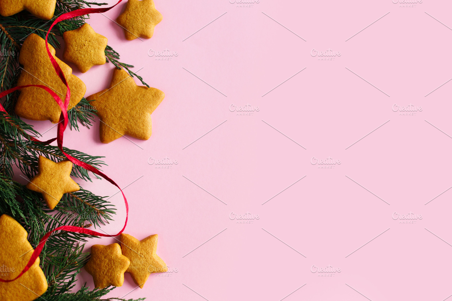 Christmas background with gingerbread cookies, fir branches and, a Photo by Sonjachni