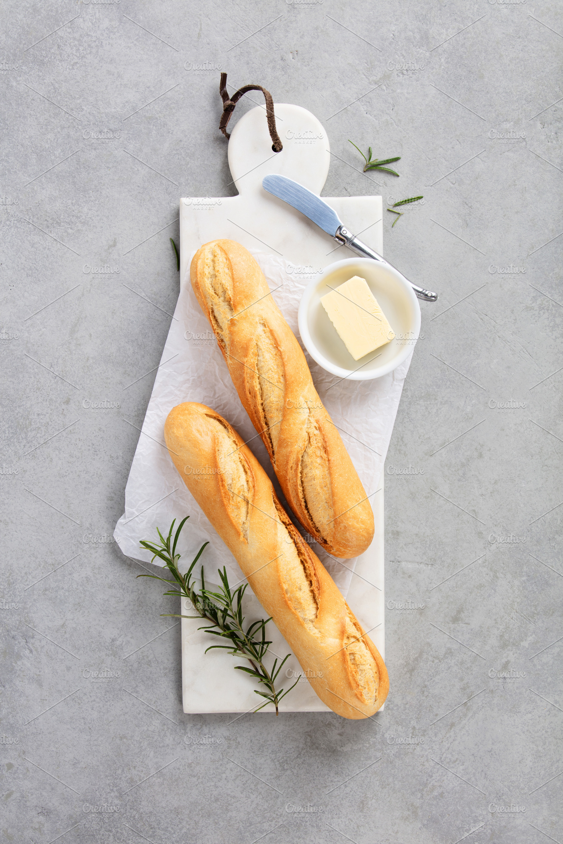 Fresh Baguettes on Marble Cutting Board with Parchment Paper, a Food & Drink Photo by Natalia Klenova's Shop