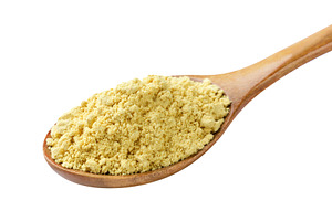 Ground mustard in a wooden spoon on, a Food & Drink Photo by innakreativ