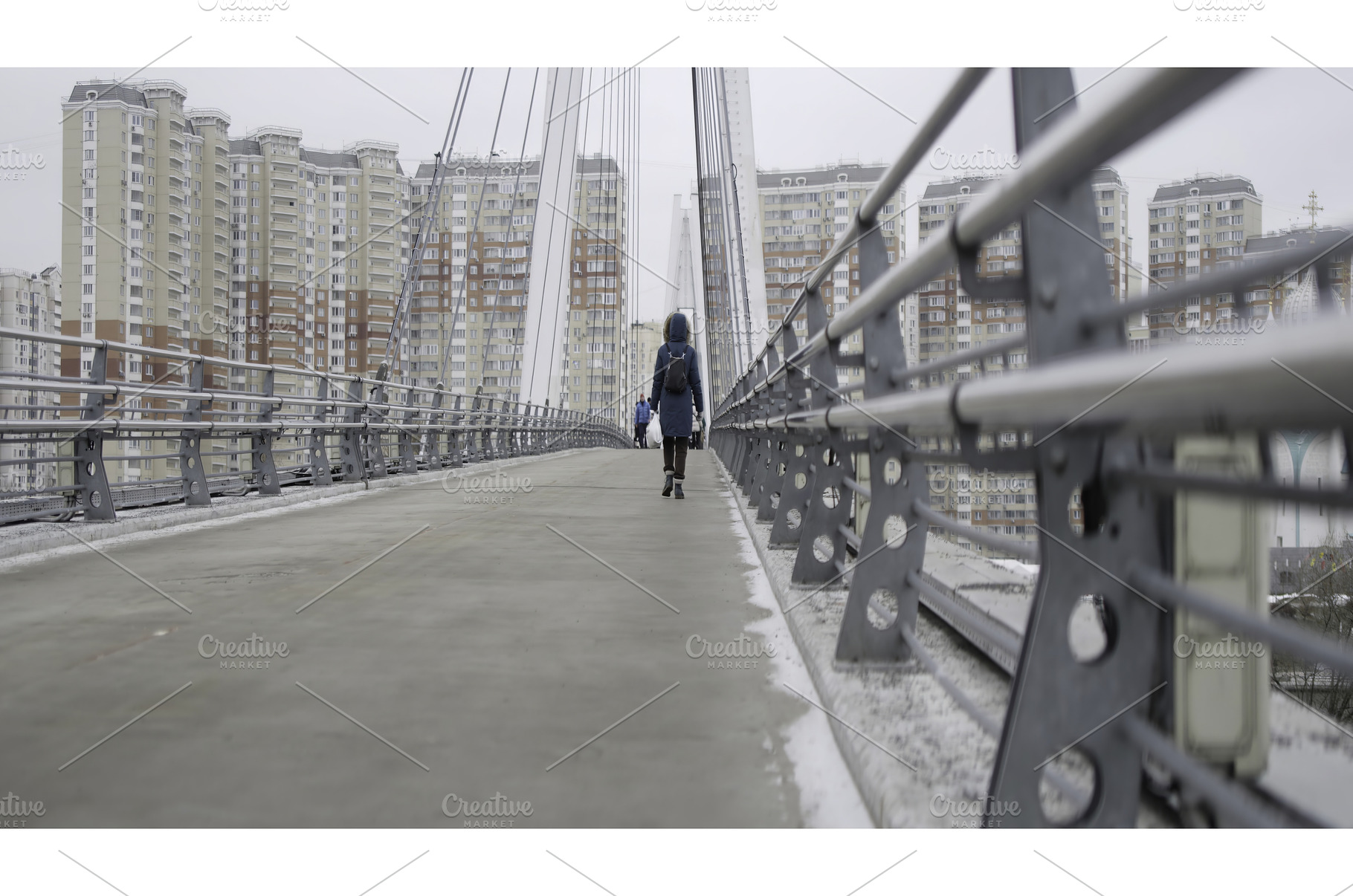 Woman walking on a cable stayed, an Architecture Photo by Media Whale Stock