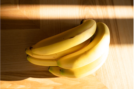 Bunch of bananas lying on the wooden, a Food & Drink Photo by oksix