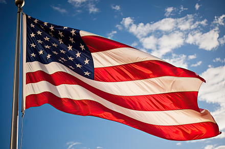 American flag waving proudly in the, a Photo by SaroStock