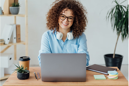 Young curly woman work on the, a Business Photo by Ksenia Neyman