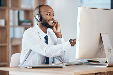 Call center, black man and consultant call of a crm, contact us and telemarketing employee. Businessman, web help and computer communication of an online consulting agent working on customer service, a Photo by Peopleimages.com