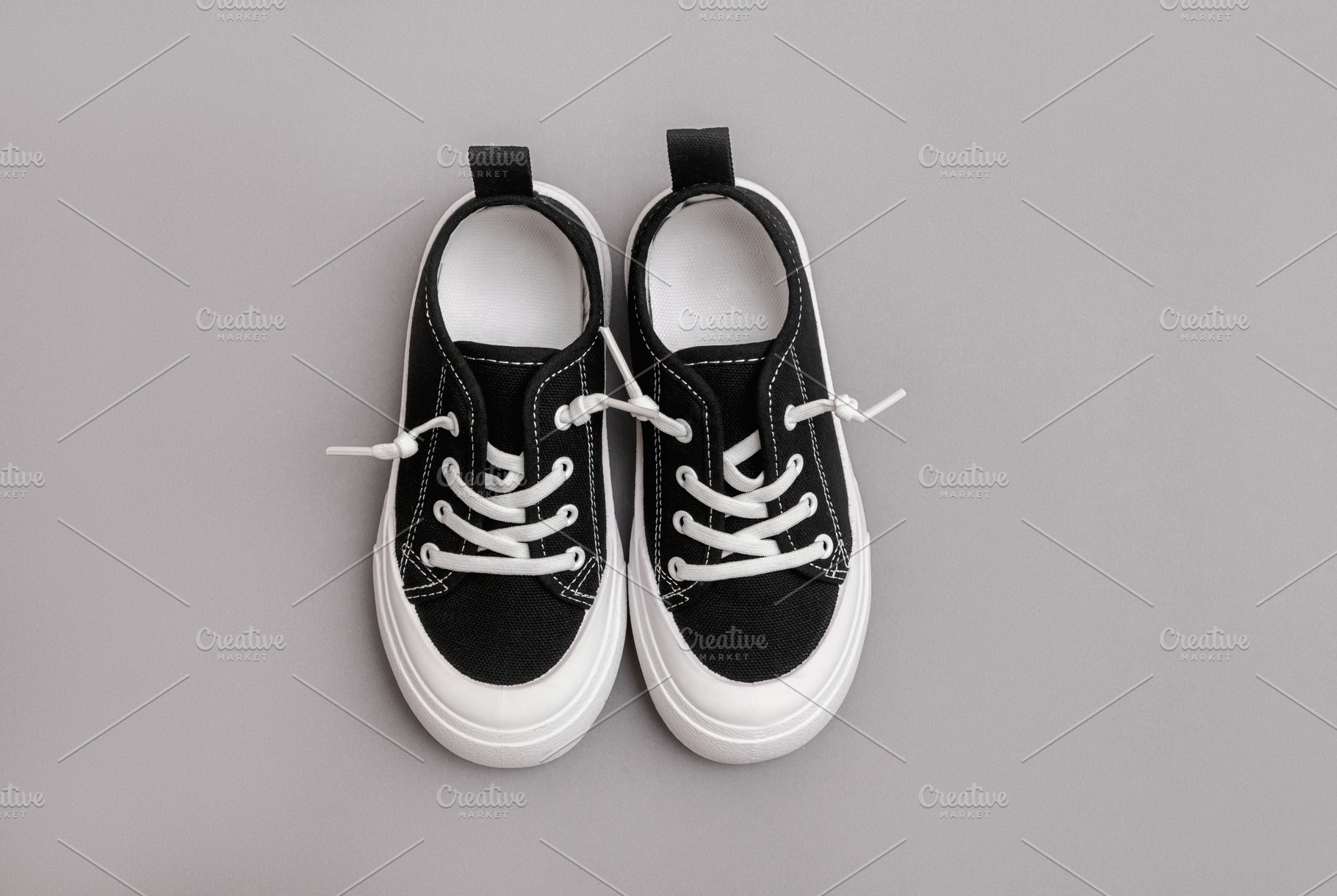 Child's black sneakers, a Beauty & Fashion Photo by Kolomiyets Viktoriya