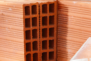 Close up of hollow clay bricks showing square holes, creating a geometric patte, an Industrial Photo by Antonio Gravante Market