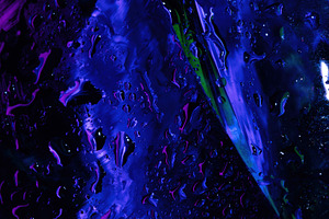 Abstract close-up of wet glass with vivid purple, blue, and gree, a Background Photo by Ales Munt