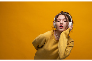 Young woman enjoying music with, a Person Photo by volodymyrshtun13795