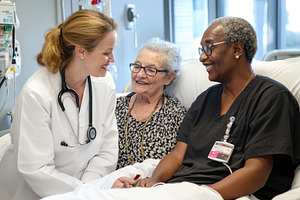 Staff member consults with patient a, a Photo by Iftikhar Alam