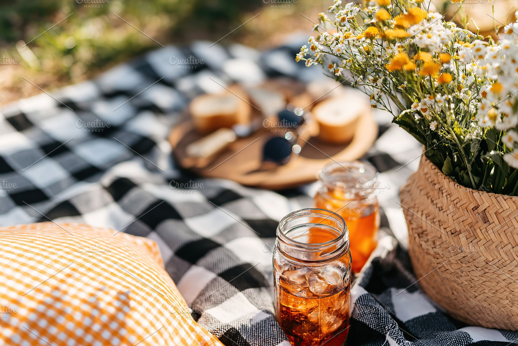 Enjoying a relaxing picnic with drinks and snacks in a city park during a sunny, a Photo by AlyaAnd