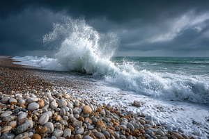 Dramatic Ocean Wave Crashing on Pebb, a Photo by Pixeness Studio