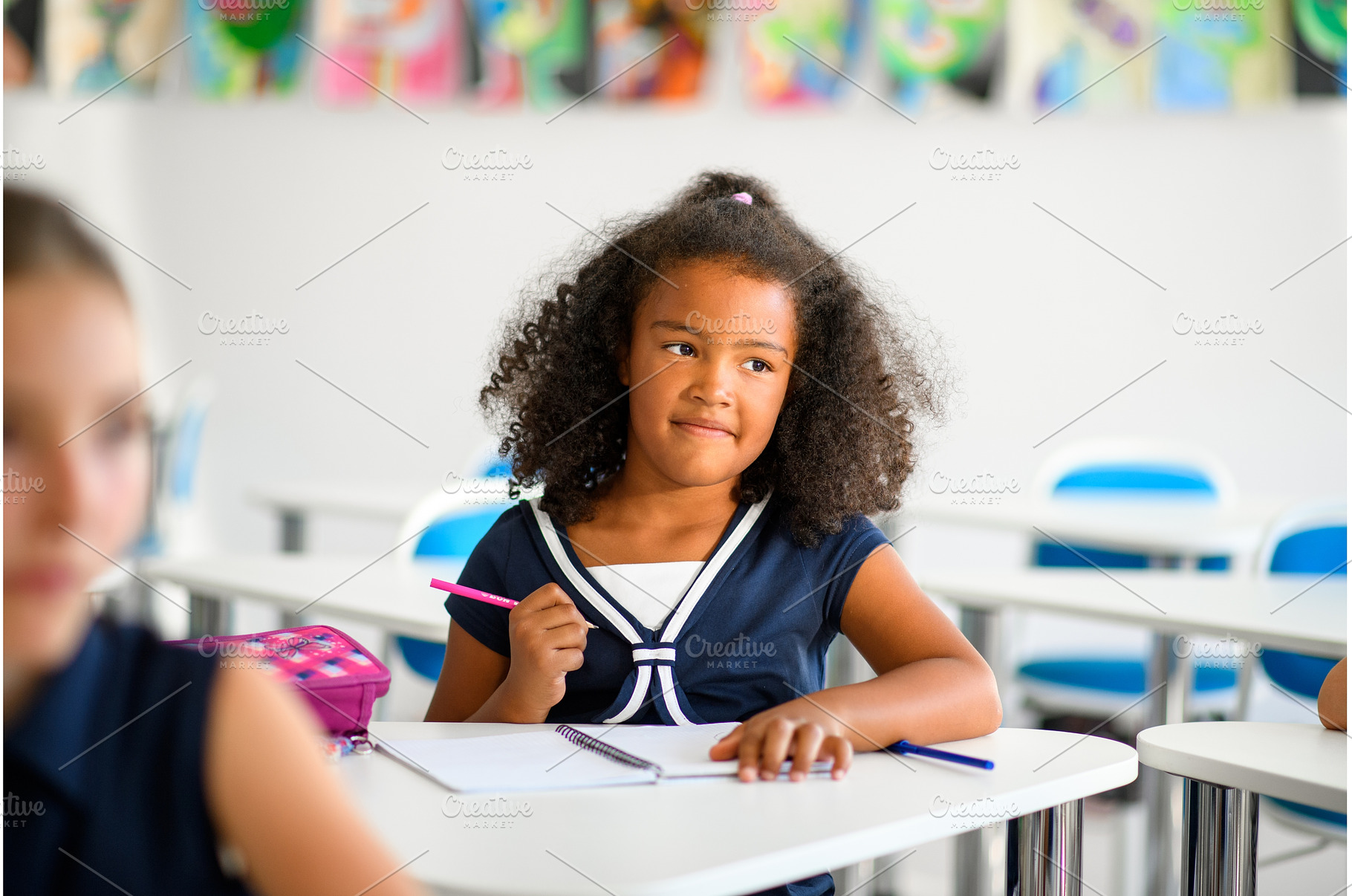 Focused schoolgirl writing notes in, a Person Photo by HalfPoint