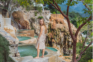 Female tourist exploring Grutas, a Nature Photo by Elizaveta Galitskaya