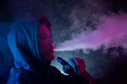 A man exhales a cloud of smoke or steam, neon style photos, a Person Photo by PavelKant