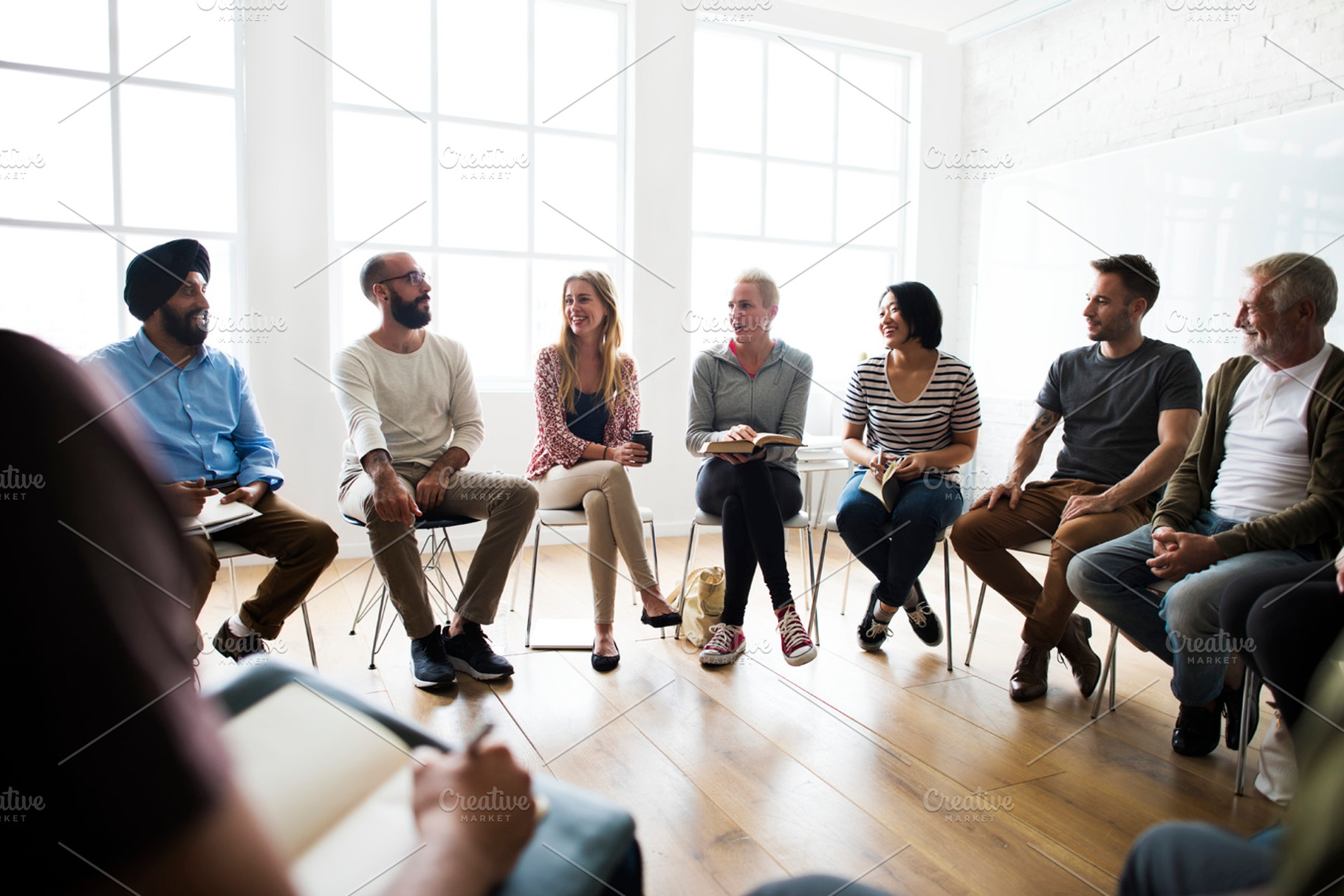 Diverse group of people in a seminar containing person, collaboration, and, a Person Photo by rawpixel