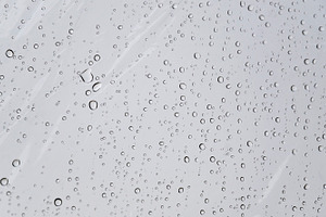 Water droplets on transparent umbrella, an Abstract Photo by neftali77