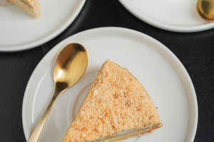 Medovik. Honey cake made from honey cakes with whipped sour cream, decorated wi, a Food & Drink Photo by Budarinphoto