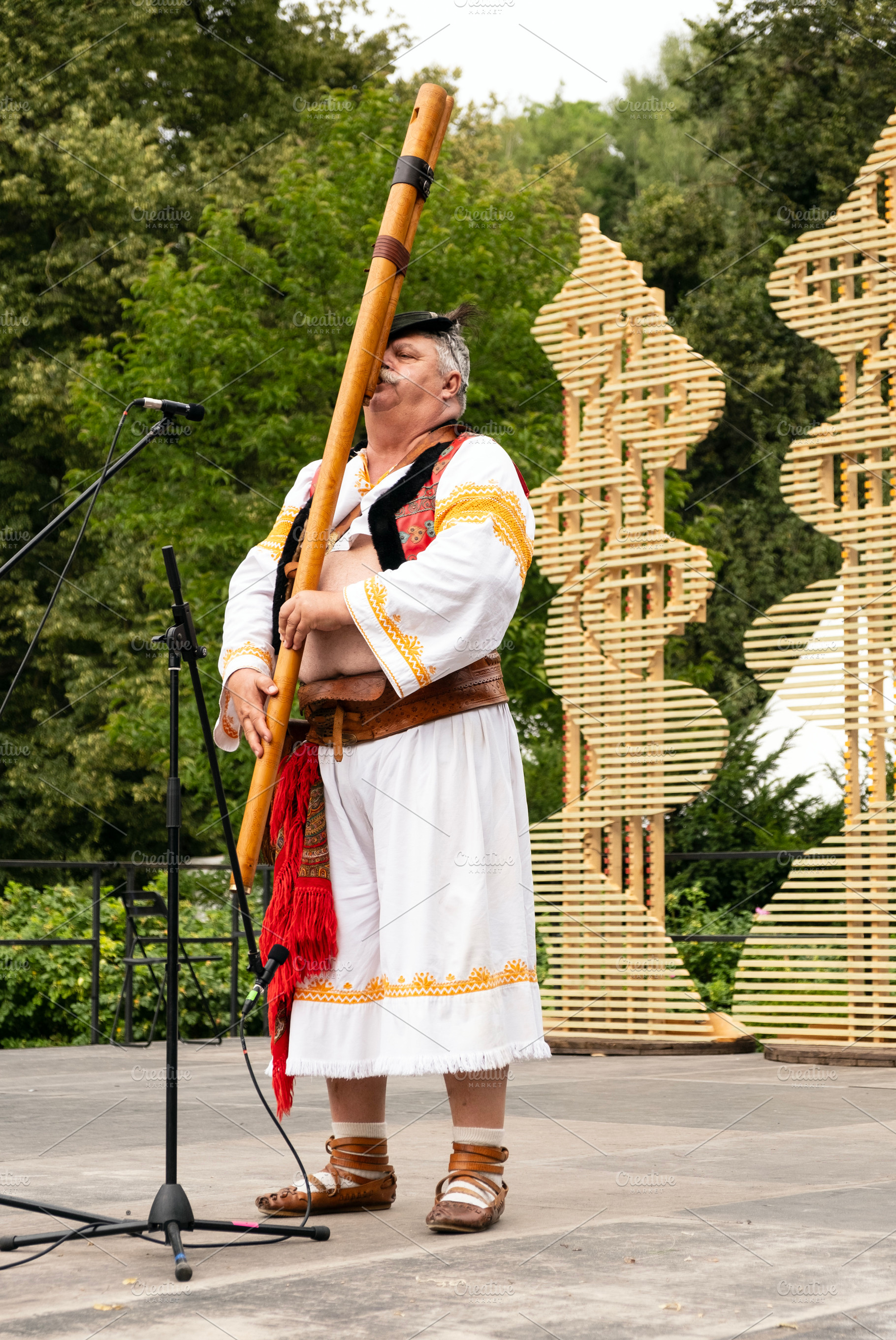 Man playing slovak fujara instrument, a Person Photo by BOOCYS