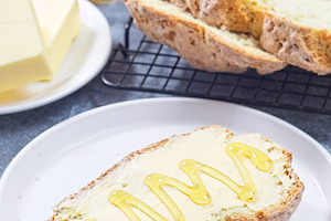 Freshly baked white Irish soda bread with butter and honey served on a plate, v, a Food & Drink Photo by iuliia_n