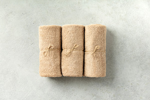 Minimalist Rolled Towels on Light Neutral Stone Background, a Beauty & Fashion Photo by Natalia Klenova's Shop