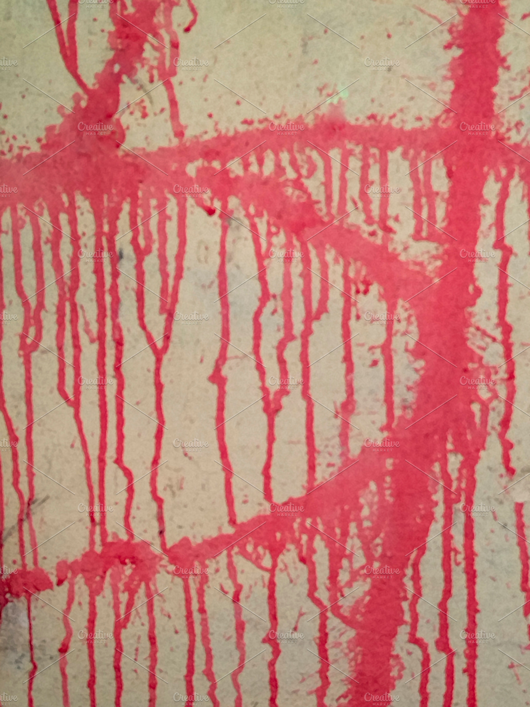 Red paint dripping down pale wall close-up, a Background Photo by DanFLCreativo