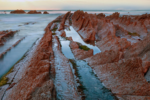 Twilight ocean coast with ribbed stratiform rock., a Nature Photo by YuriyB