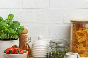 Empty wooden cutting board with various ingredients and utensils, a Food & Drink Photo by Olena Rudo