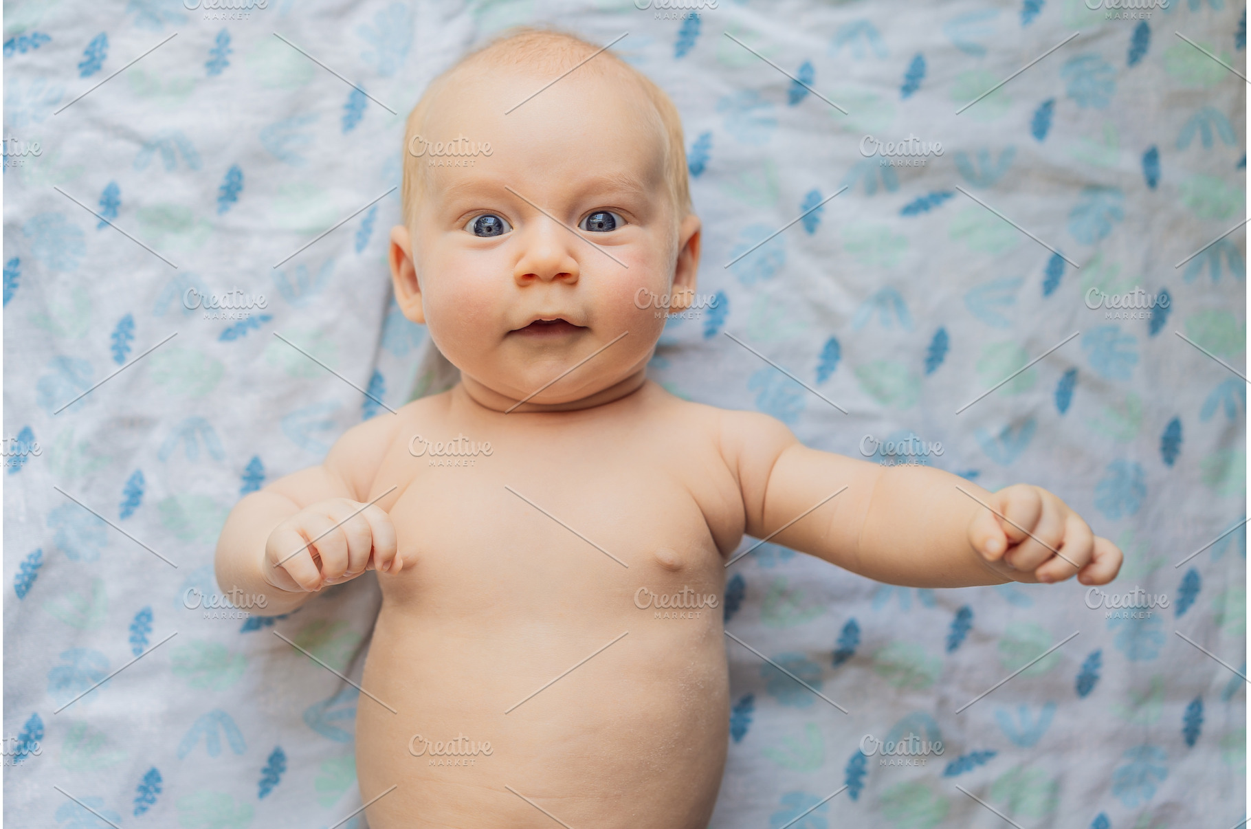 Curious baby lying on a soft blanket, a Person Photo by Elizaveta Galitskaya