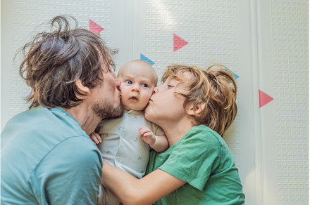 Father, son, and newborn baby lying, a Person Photo by Elizaveta Galitskaya