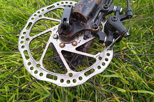High angle close-up of a bicycles front wheel over grass, a Transportation Photo by DanFLCreativo