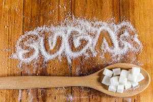 'Sugar' written and cubes on spoon