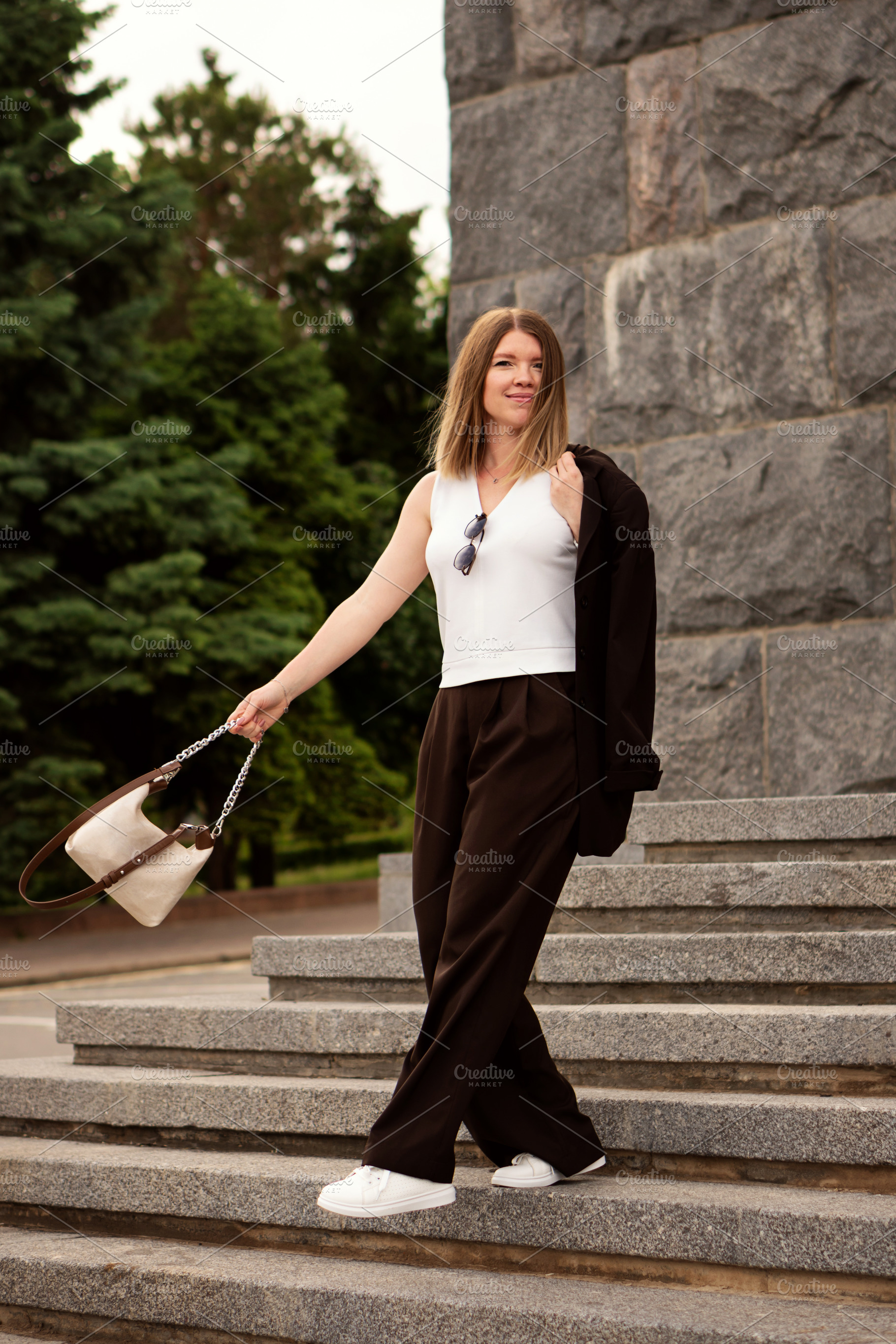 Young woman posing elegantly on ston, a Person Photo by Elena Vagengeim
