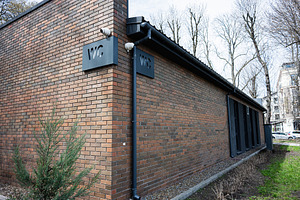 Modern public restroom building with clear signage in a natural urban setting, a Photo by AS photostudio
