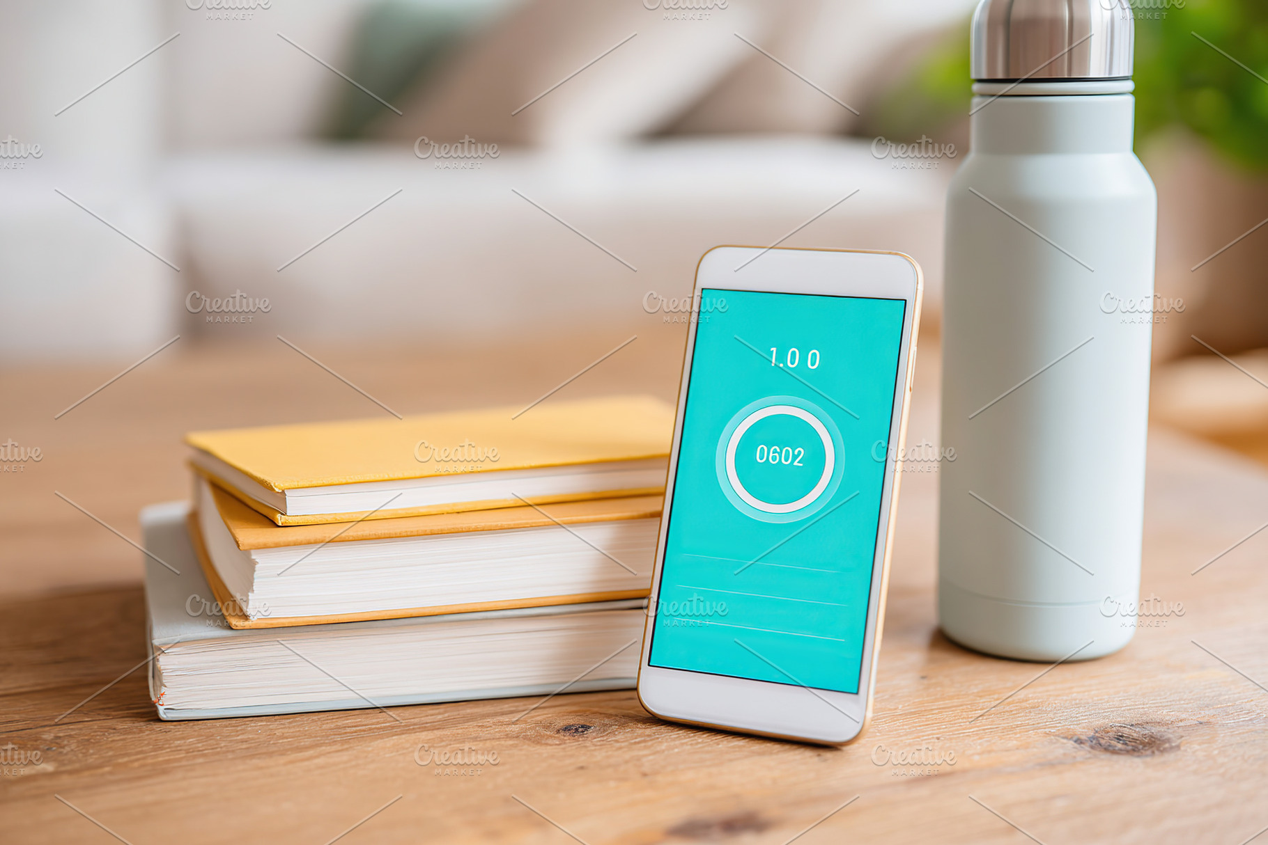 Smartphone and water bottle on wooden desk with books during study session, a Photo by AlyaAnd