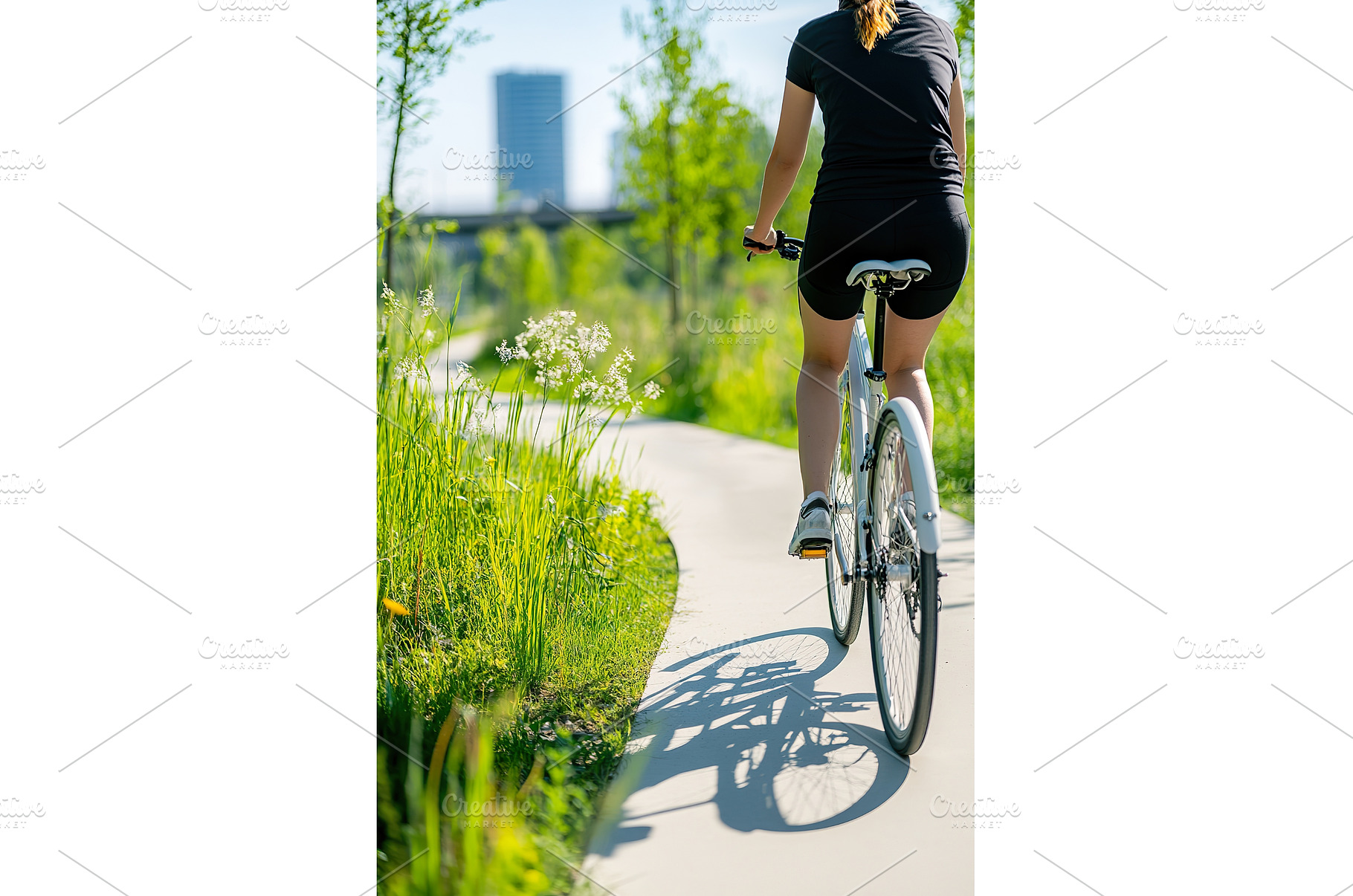 Female cyclist on sunny path in lush, a Sports & Recreation Photo by Lermont51