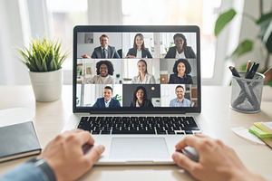 Laptop screen displaying a grid of diverse professionals in a vi, a Technology Photo by DanFLCreativo
